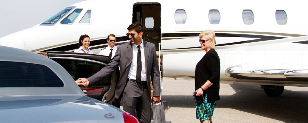 business man at airport exiting a car wide shot