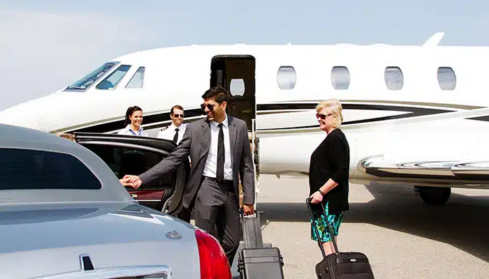 business man at airport exiting a car