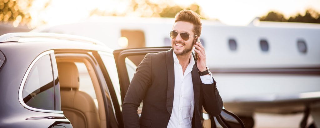 business man exiting consierge vehicle wide shot