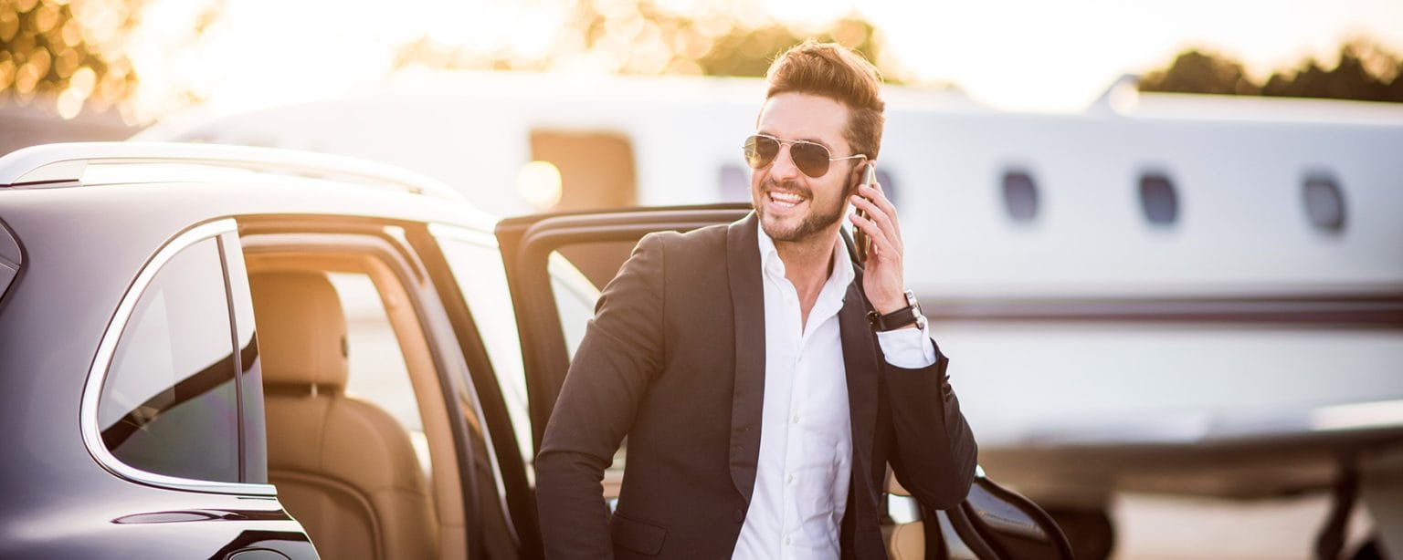 business man exiting consierge vehicle wide shot