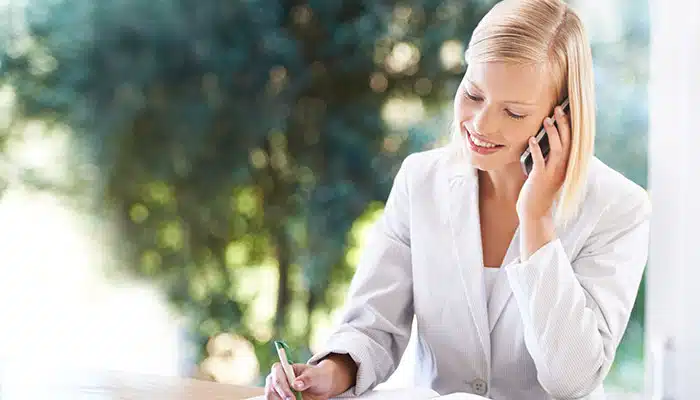 woman on phone booking a consierge vehicle