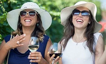women laughing drinking wine small