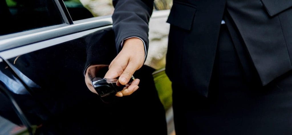 man opening limo door